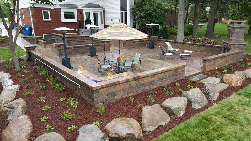 outdoor-living-space-brick-paver-fireplace-patio-retaining-wall-fire-table