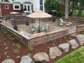 outdoor-living-space-brick-paver-fireplace-patio-retaining-wall-fire-table
