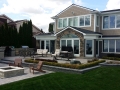 outdoor-living-space-retaining-wall-firepit-kitchen-paver-patio
