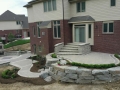 outdoor-living-space-stone-retaining-wall-paver-fireplace-patio